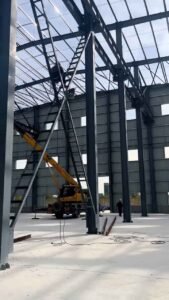 X-shaped steel cross-bracing tensioners installed on the walls of a wind-resistant warehouse.