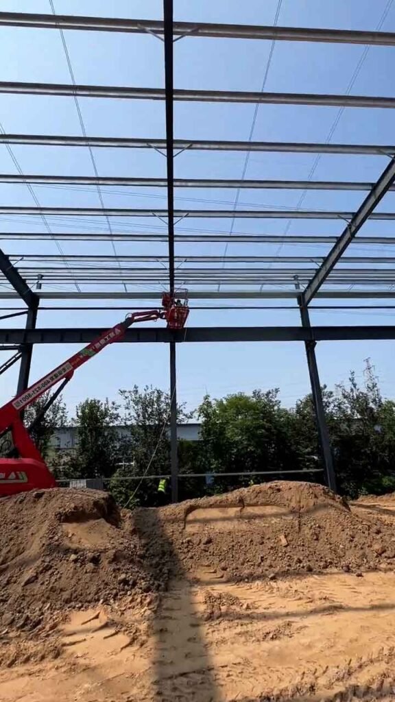 Sistema de techado con planchas metálicas y franjas translúcidas en un galpón metálico prefabricado.