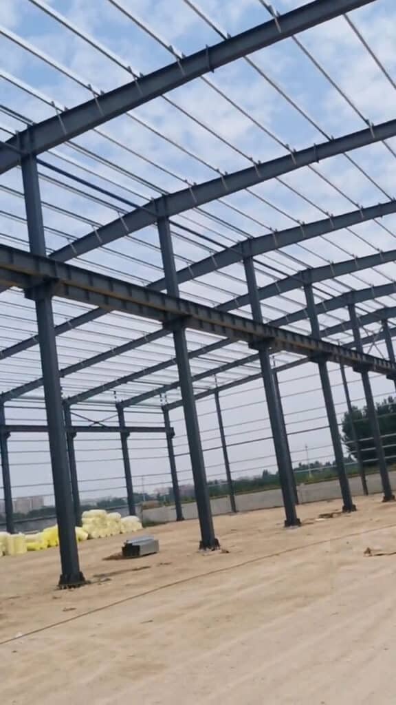 Esqueleto de un edificio de acero prefabricado con vigas maestras alineadas y diseño de gran luz para naves logísticas