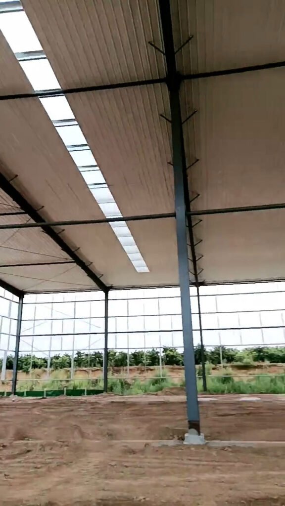 Vertical perspective of a galvanized steel warehouse frame showing the clean finish of the pillars and rafters