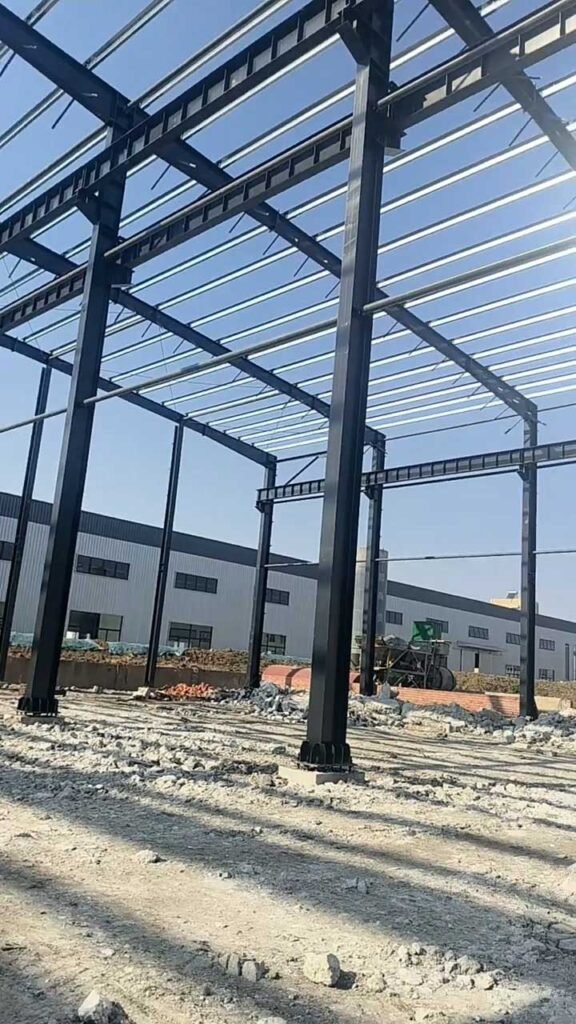 Upward perspective of a high load steel structure highlighting the precision-engineered beam-to-column connections.