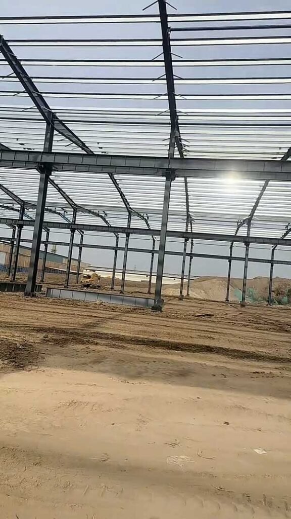 Massive steel skeleton of a turnkey warehouse project in a desert climate area with wide-span frames.