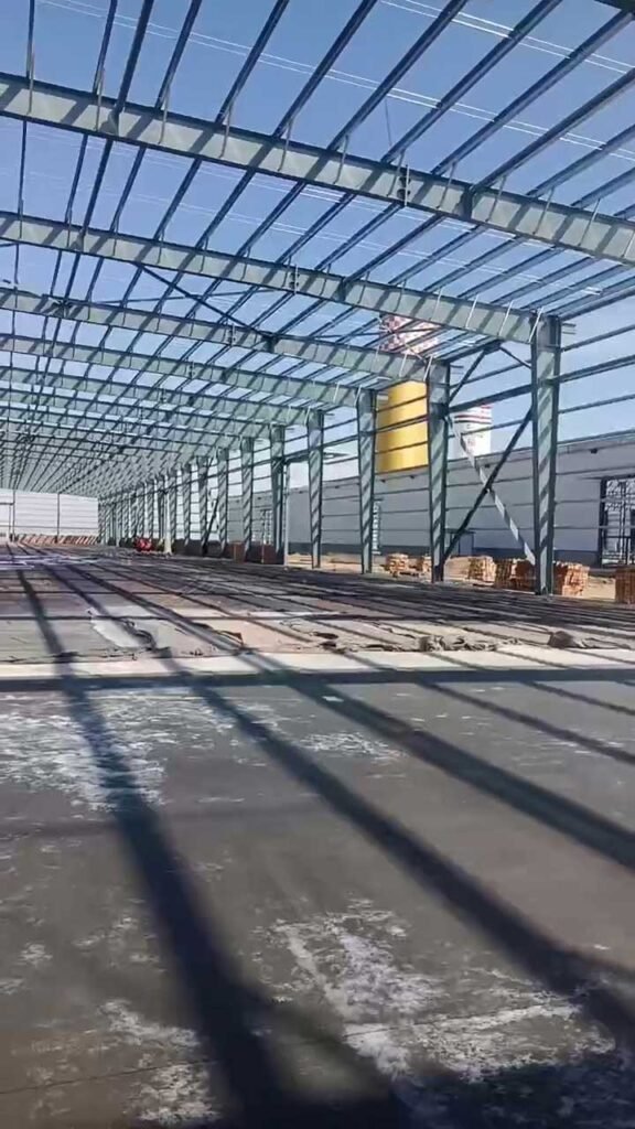 Galvanized roof purlin installation on an affordable prefab warehouse showing efficient material usage and structural alignment.