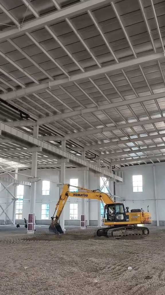 Wide interior perspective of a commercial steel building highlighting the strategic placement of side-wall windows for natural ventilation and daylighting.