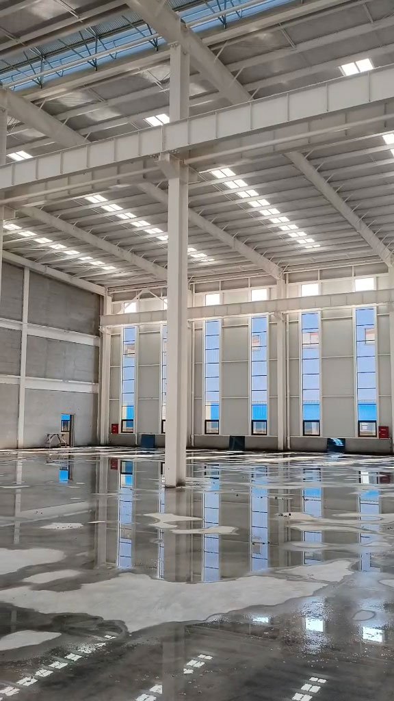 Spacious interior of a custom engineered facility featuring precise column and beam alignment, manufactured exactly to client specifications by a custom steel structure manufacturer.