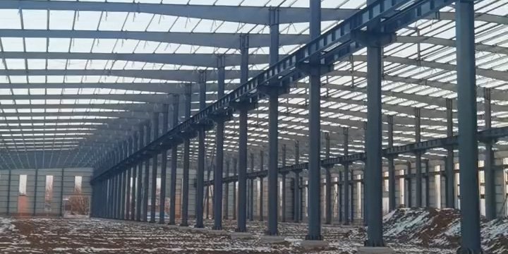Main steel columns and crane beams installed in a heavy industrial steel structure imported from China, showing wide clear span engineering.
