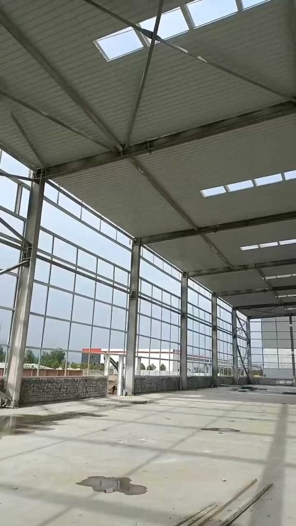 Expansive roof structure with integrated skylight panels and heavy-duty steel trusses, engineered by an industrial steel structure supplier for natural lighting.