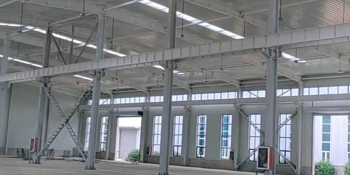 Expansive roof structure with integrated skylight panels and heavy-duty steel trusses, engineered by our industrial steel warehouse factory for natural lighting and energy efficiency.