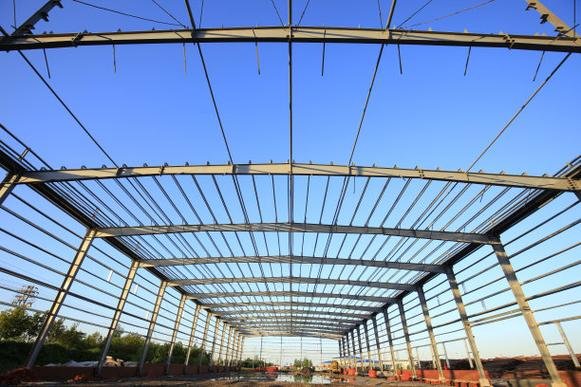 Exterior perspective of multiple structural bays for a manufacturing facility, demonstrating the scale capacity of an expert industrial warehouse exporter