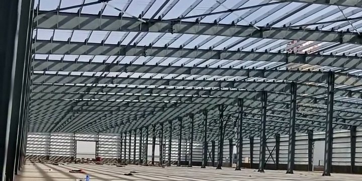 Low-angle shot of roof truss grid and purlin connections manufactured by a specialized industrial warehouse supplier.