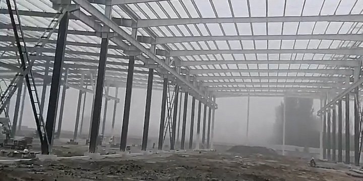 Expansive wide-angle view of a large logistics center's framework, proving how maximizing clear spans and building size can optimize the overall PEB price per square meter.
