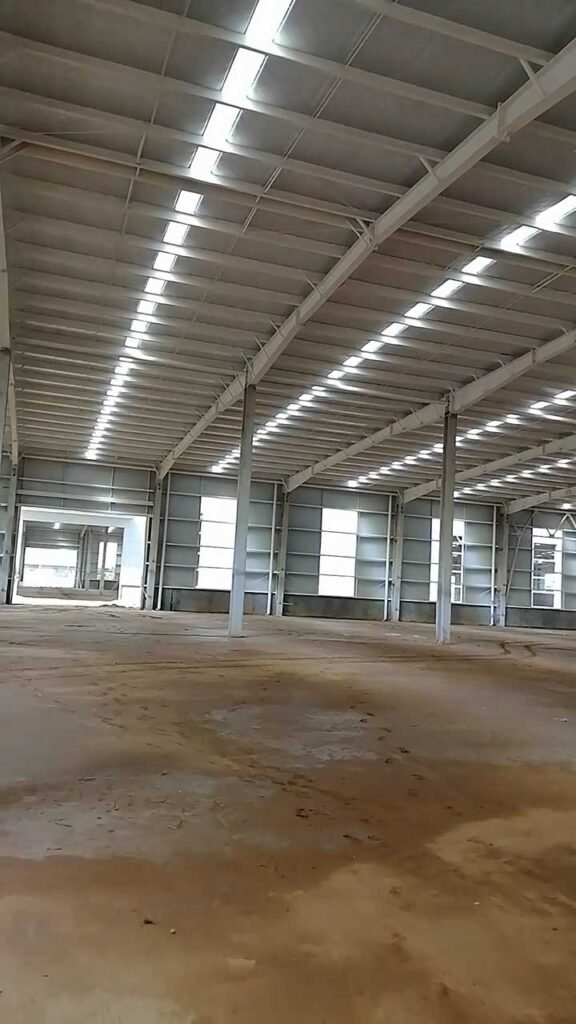 Roof framework featuring continuous energy-saving skylights and Q355 structural steel, a smart engineering choice that reduces long-term operational and prefabricated warehouse cost.