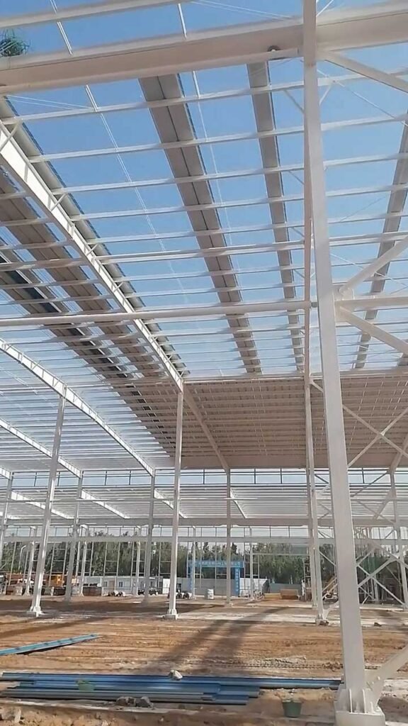 Looking upward at the symmetrical structural grid and roof bracing of a commercial building, reflecting the engineering precision required in a prefabricated warehouse quotation.