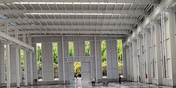 Interior view of a white painted steel structure, demonstrating the high-quality surface treatment and precise framing provided by a reliable steel building OEM factory.