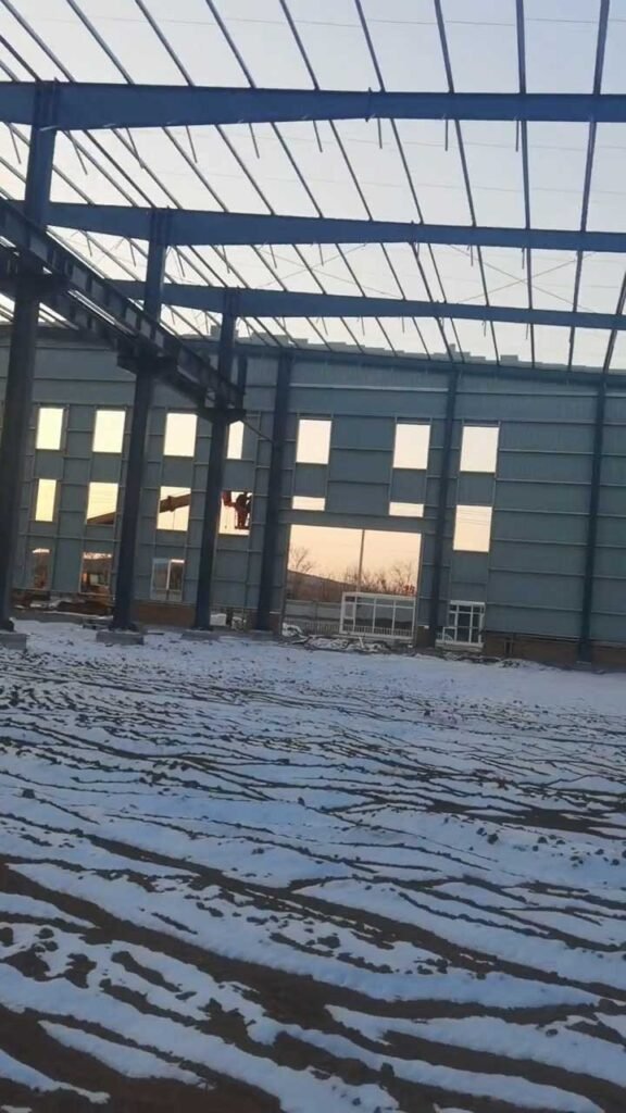 Secondary steel framing including wall girts and structural window openings ready for cladding on a commercial steel building.