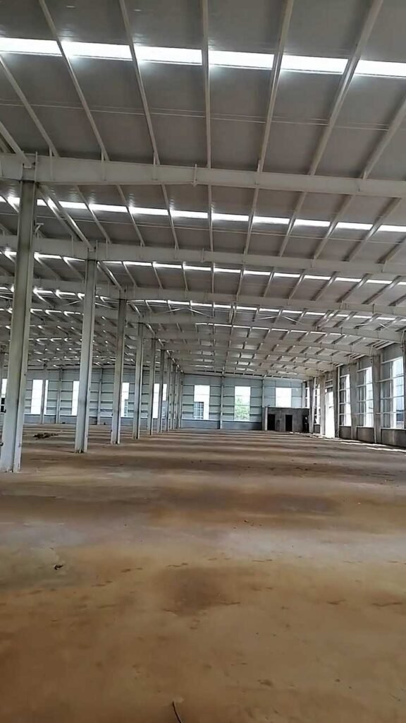 Expansive multi-span interior framework before floor pouring, illustrating the massive scale and material requirements factored into a steel warehouse construction cost.