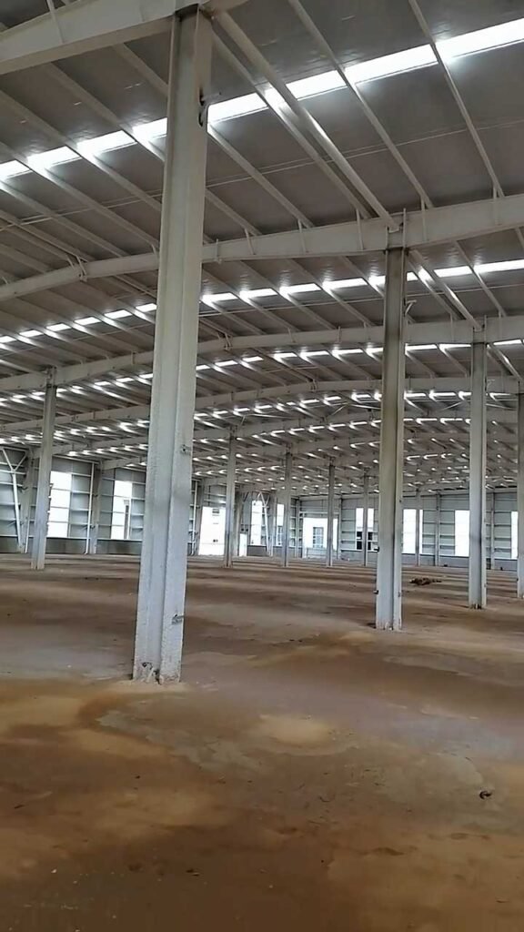 Wide angle of prefabricated structural steel columns and galvanized roof purlins used by engineers to estimate an accurate commercial warehouse building budget.