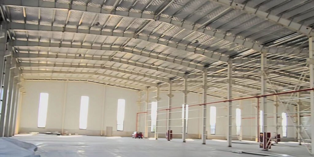 Vista interior de nave industrial con aislamiento térmico producida a medida por un fabricante OEM de estructuras metálicas.