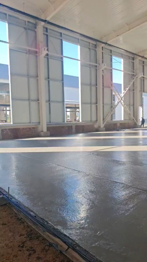 Structural engineering for warehouse building displaying columns, bracing, and concrete floor installation