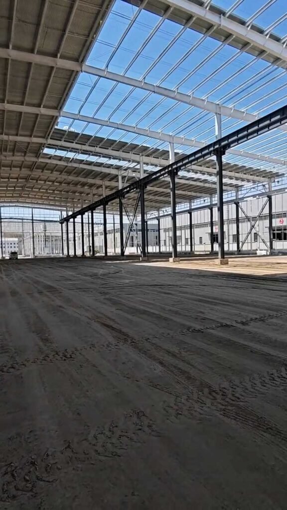 Heavy industrial structural steel framing with wall girts and roof support beams.