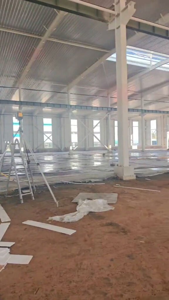 Interior frame structure displaying wall girts, roof purlins, and bracing in a steel warehouse.
